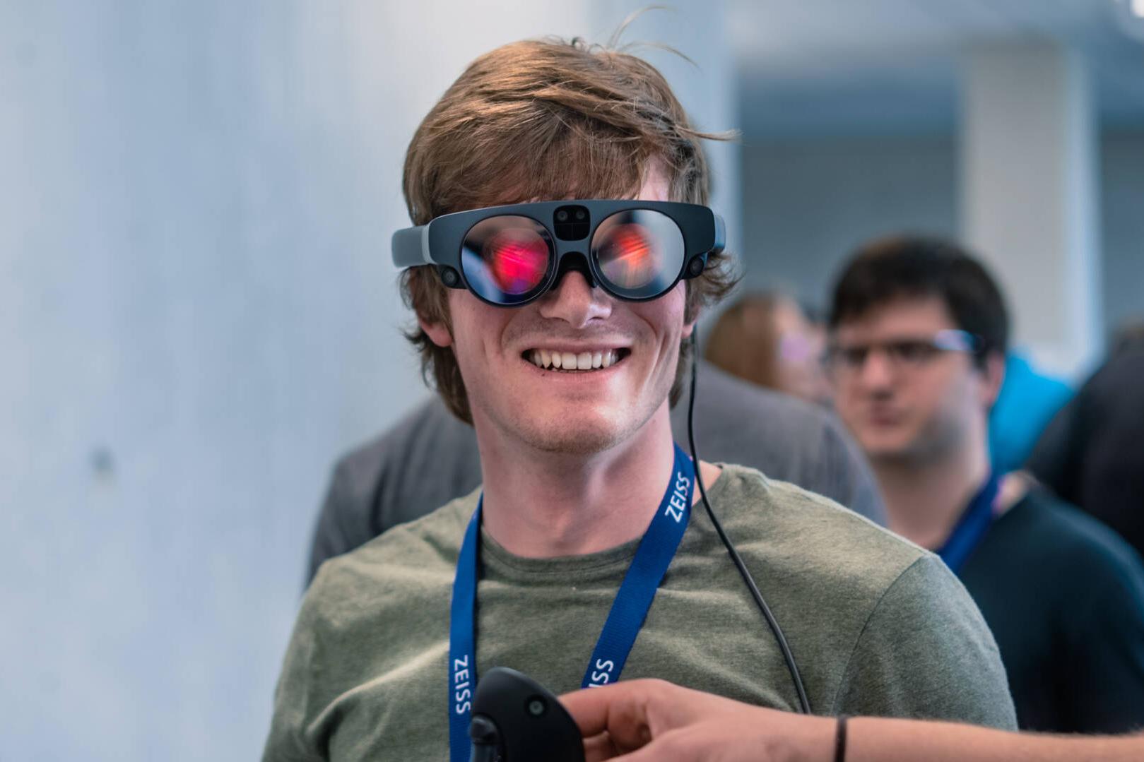 A hackathon participant wearing AR goggles.