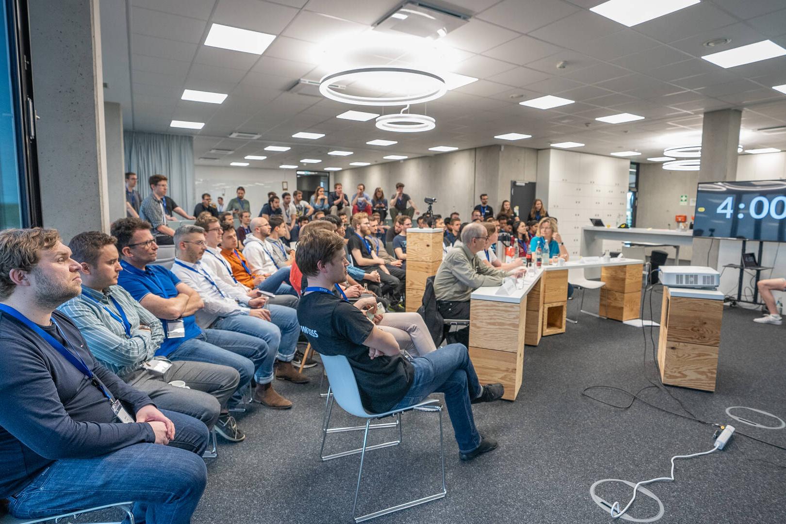 The participants of the hackathon watching a presenation.