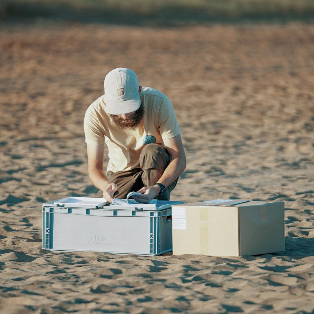 A scientist takes samples at the beach