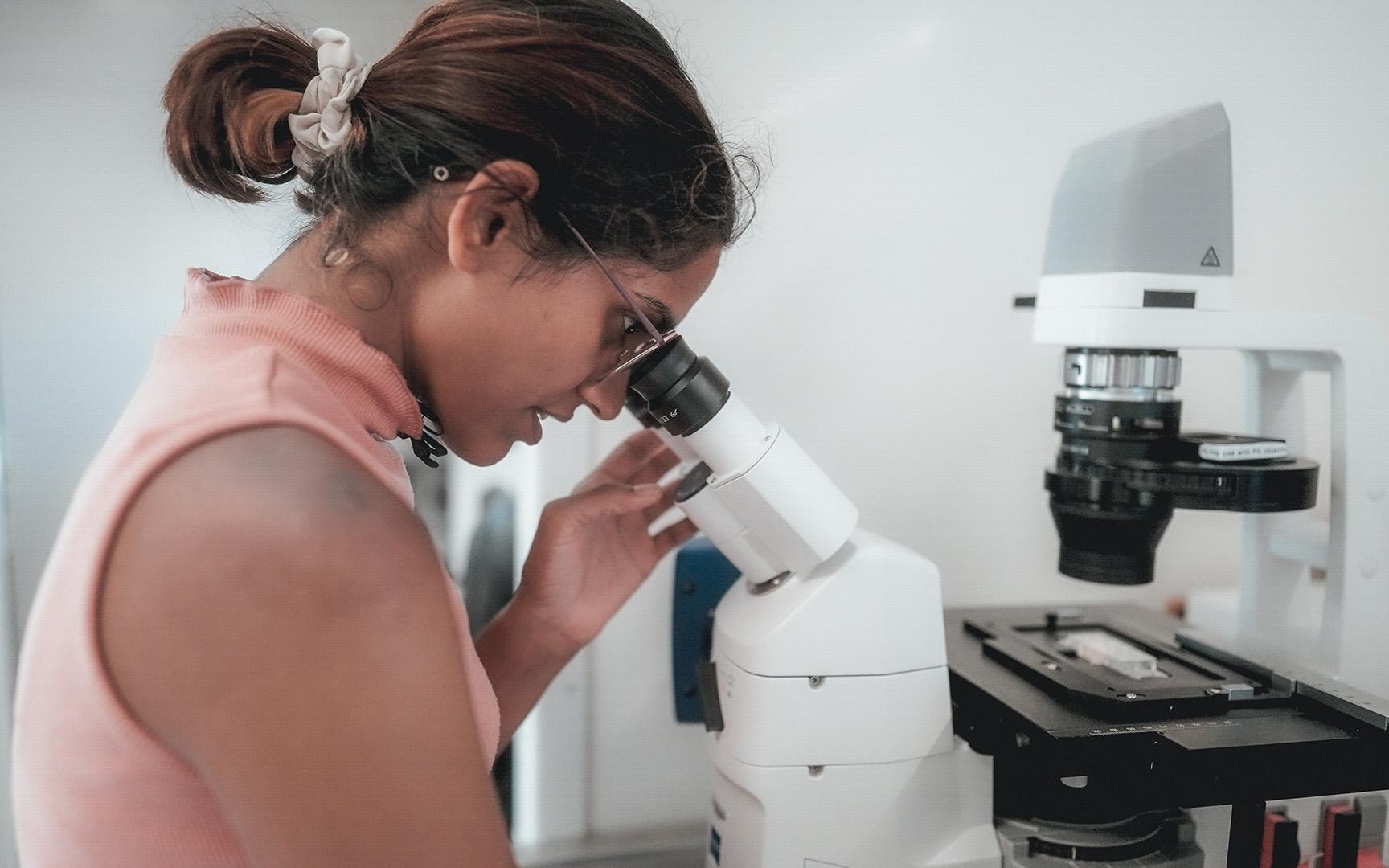 Scientist working at a microscope in the laboratory
