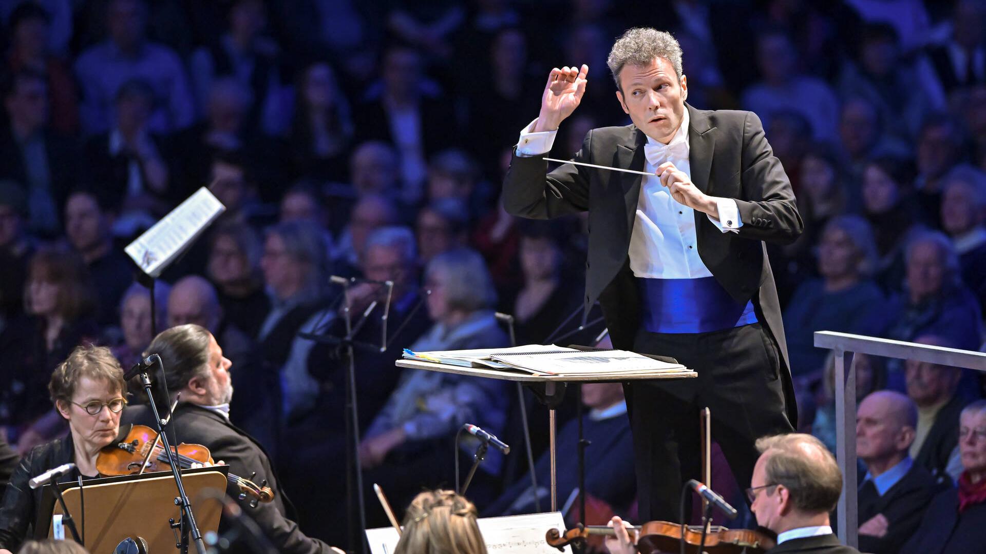 A conductor conducting an orchestra during a concert