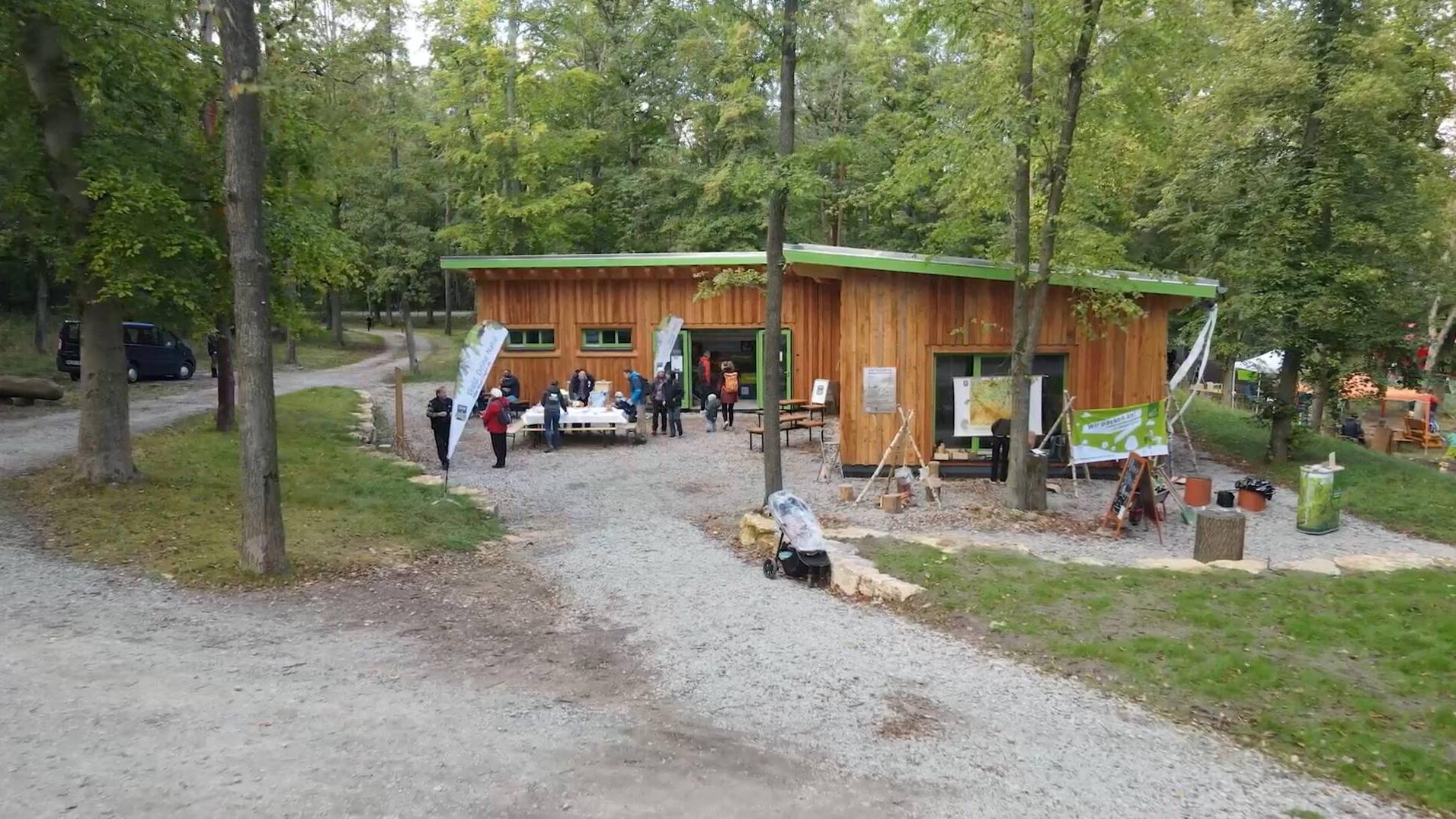 A cabin in the forest hosting an information event on nature conservation