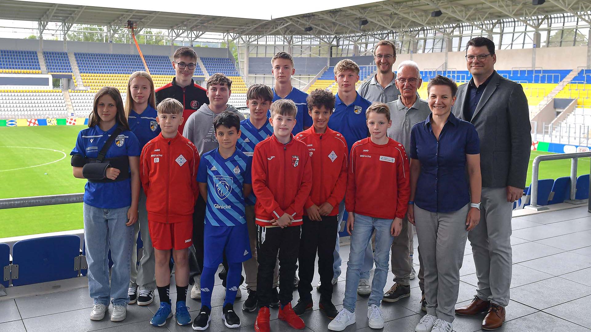 Young soccer players stand for a group photo on the Ernst Abbe sports field in Jena