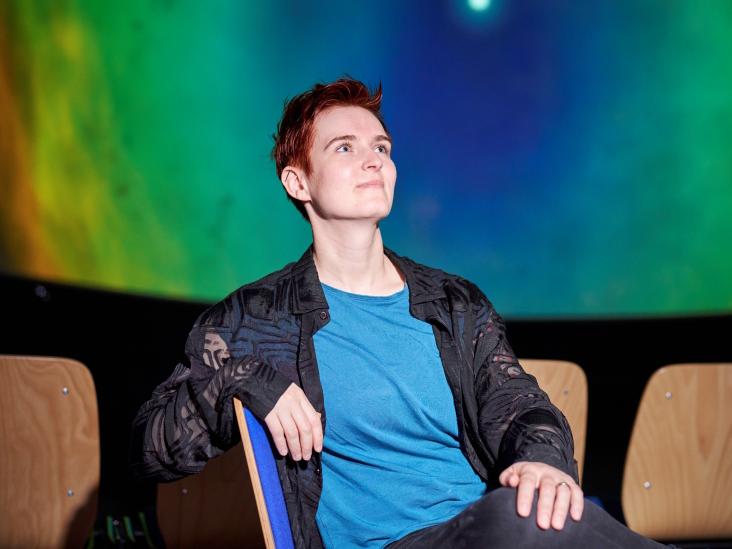 Louisa Pragst sits in a planetarium projection room.