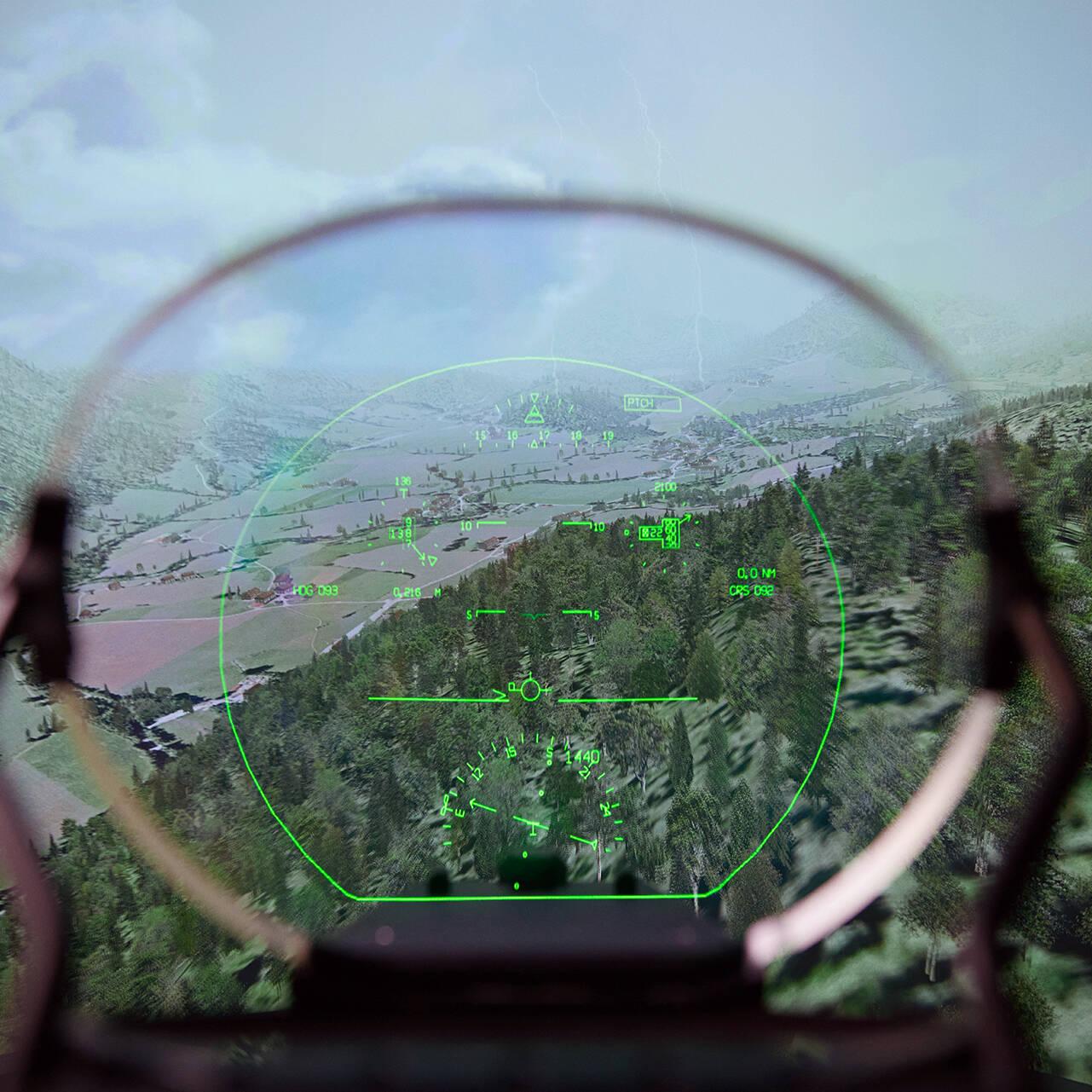 View through an AR head-up display model of a cloudy mountain landscape from an airplane.