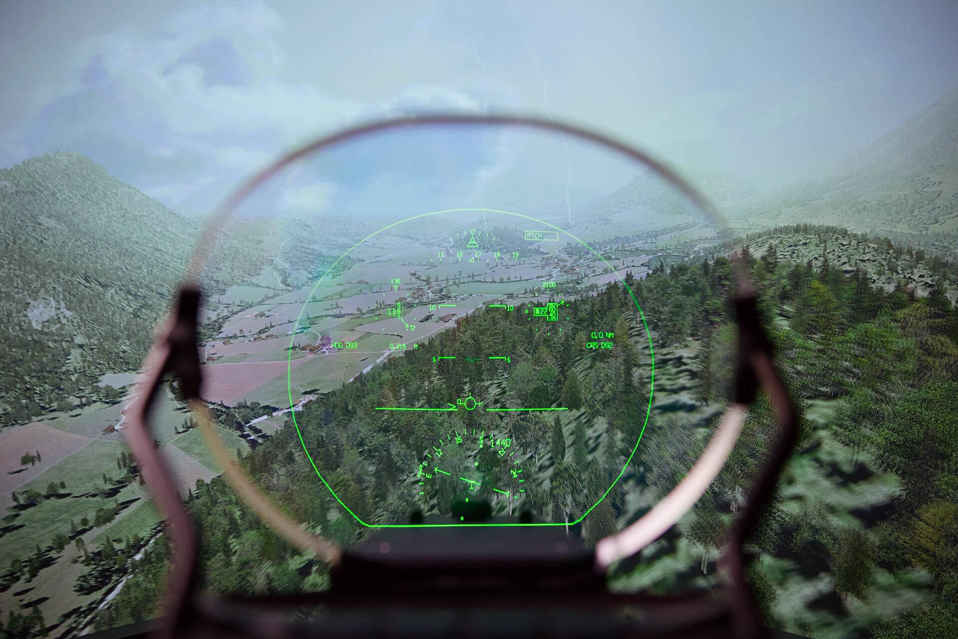 View through an AR head-up display model of a cloudy mountain landscape from an airplane.