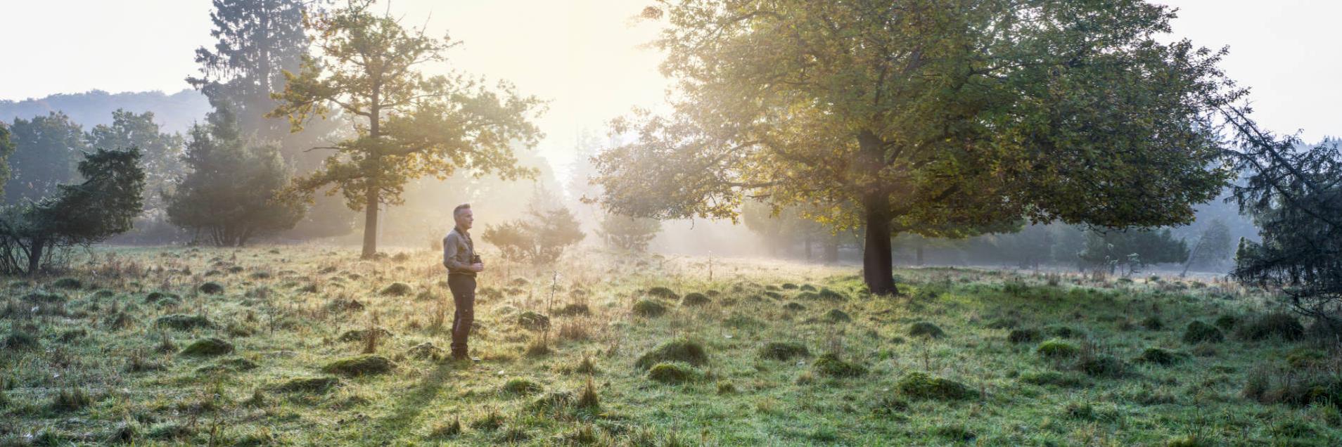 Nick Baker standing on a grassy meadow.