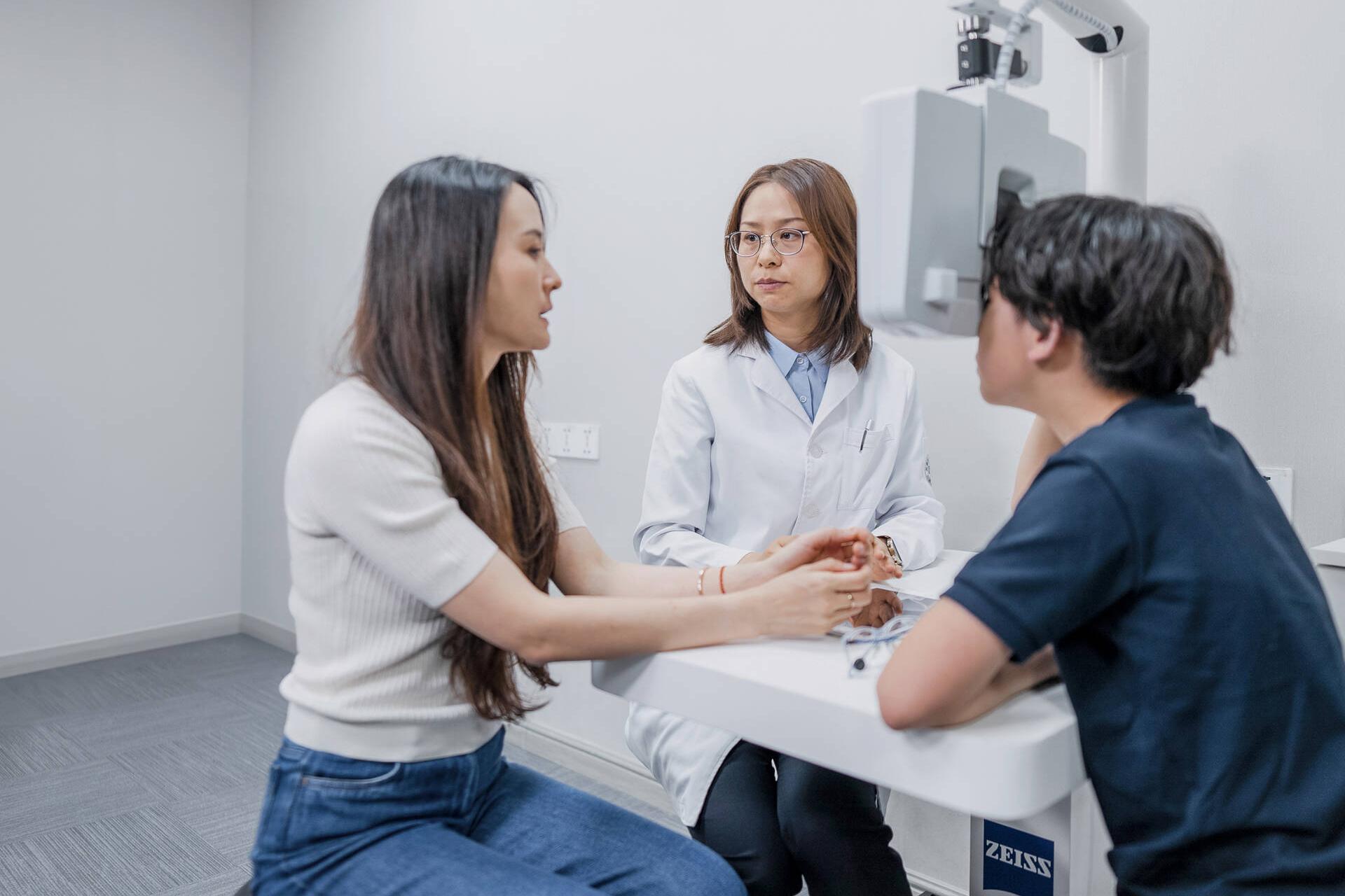 Aidan Zhong taking an eye test administered by Dr. Chen Xiaoqin