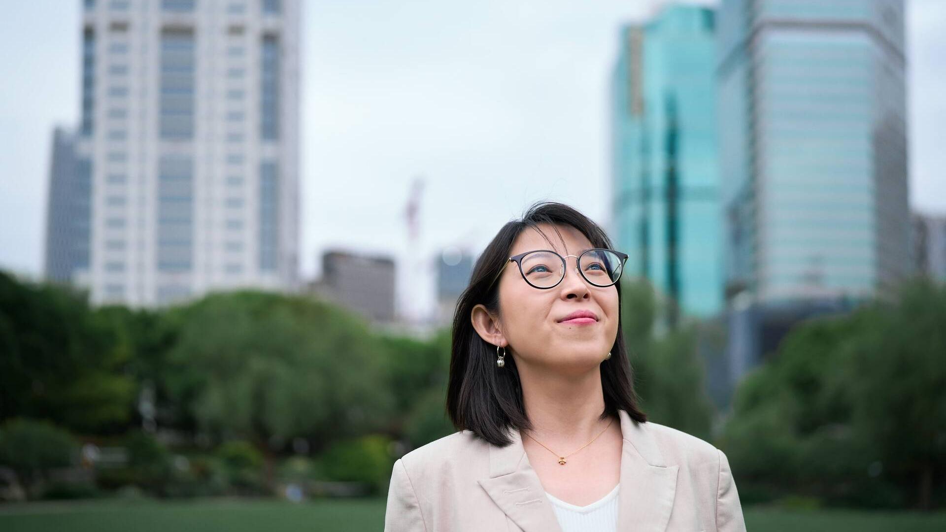 Yuqing Bai standing outside in a park in Shanghai