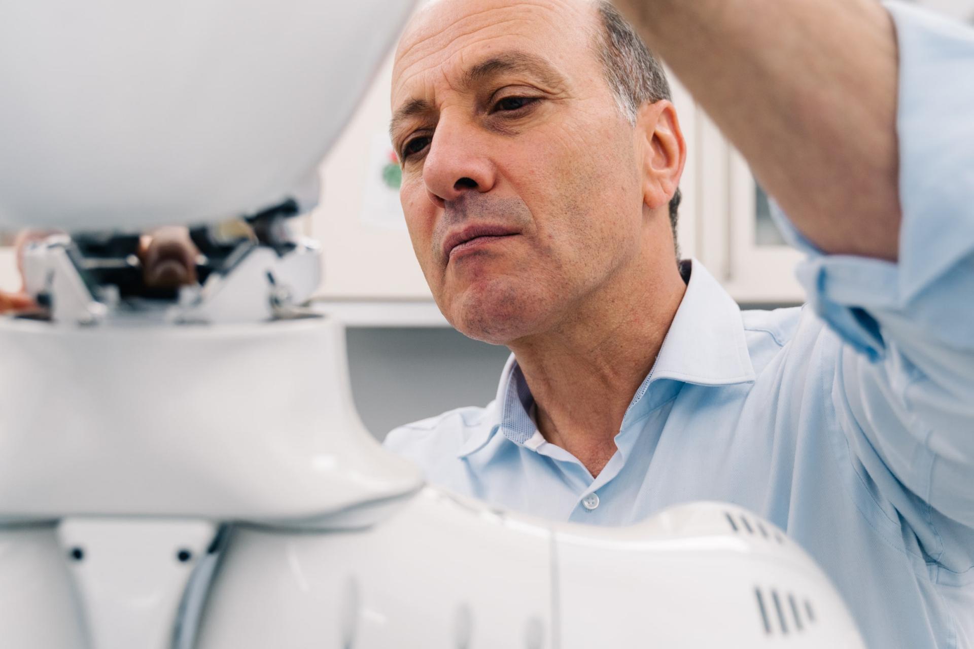 Prof. Dr. Tamim Asfour works on a robot in the lab