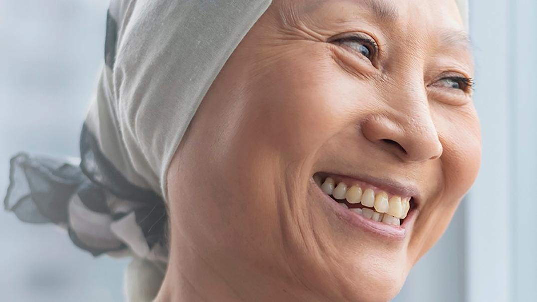 Hope in the fight against breast cancer laughing woman with head scarf
