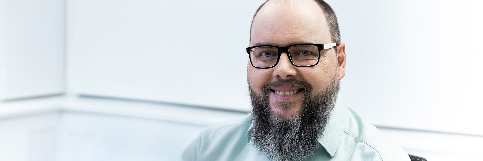 Portrait of Sven, who is smiling and looking warmly at the camera