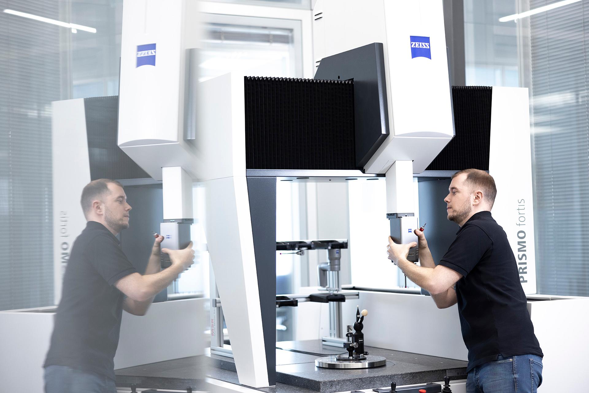 Marwin attaches a component to a ZEISS machine.