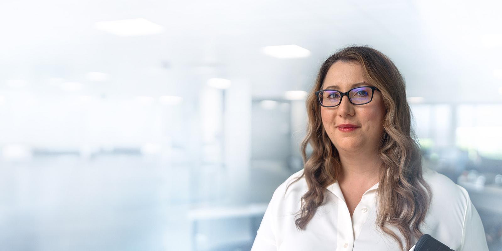 ZEISS Employee, holding a tablet in her hands.