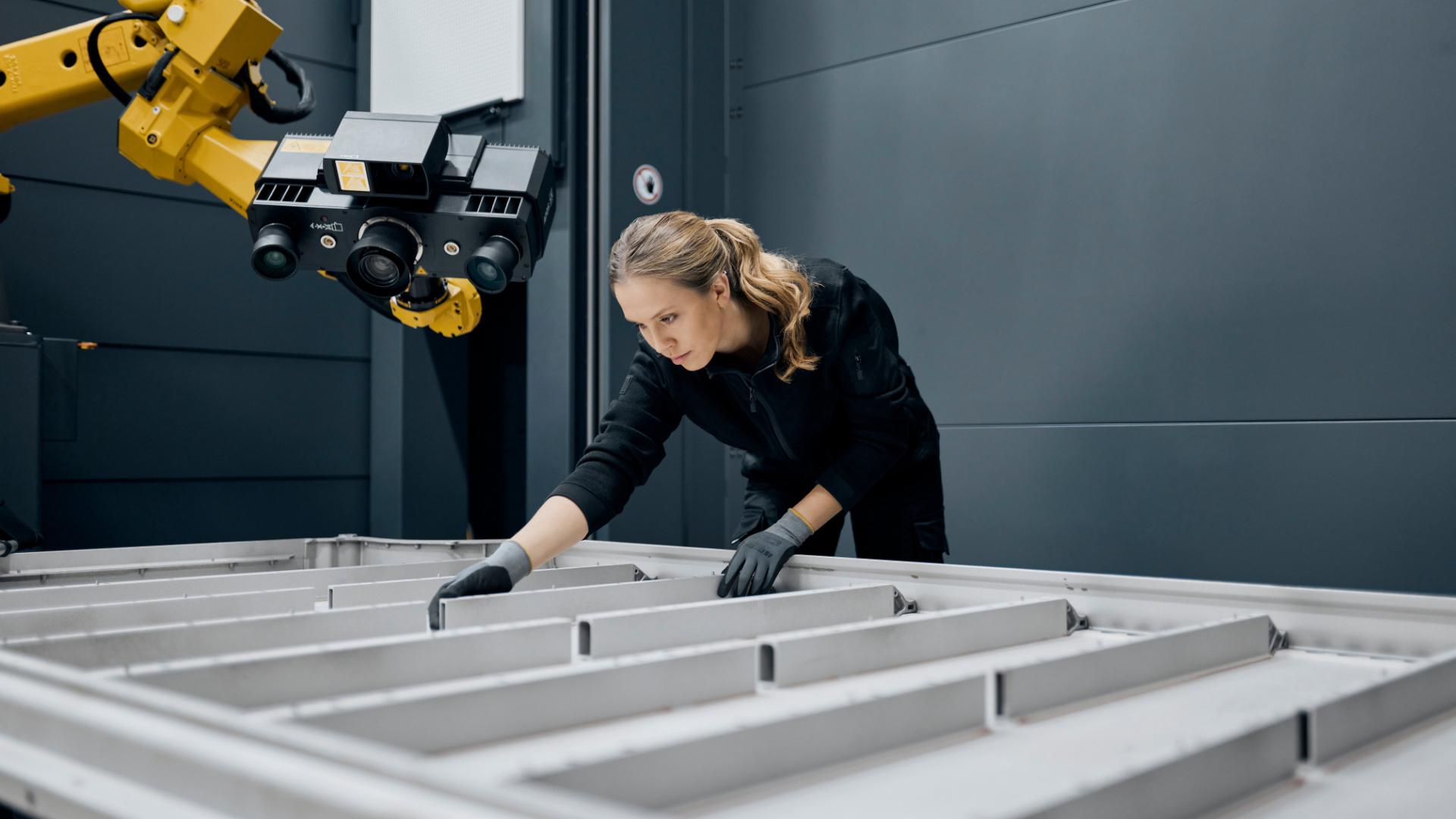A person carries out the battery tray inspections process