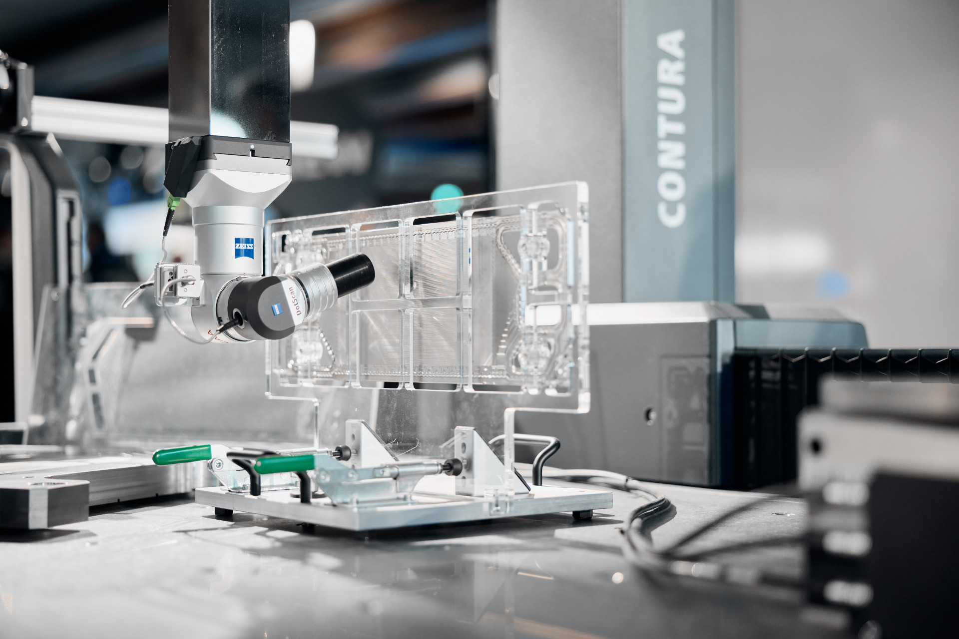 A ZEISS coordinate measuring machine inspects a transparent plastic component with high precision.