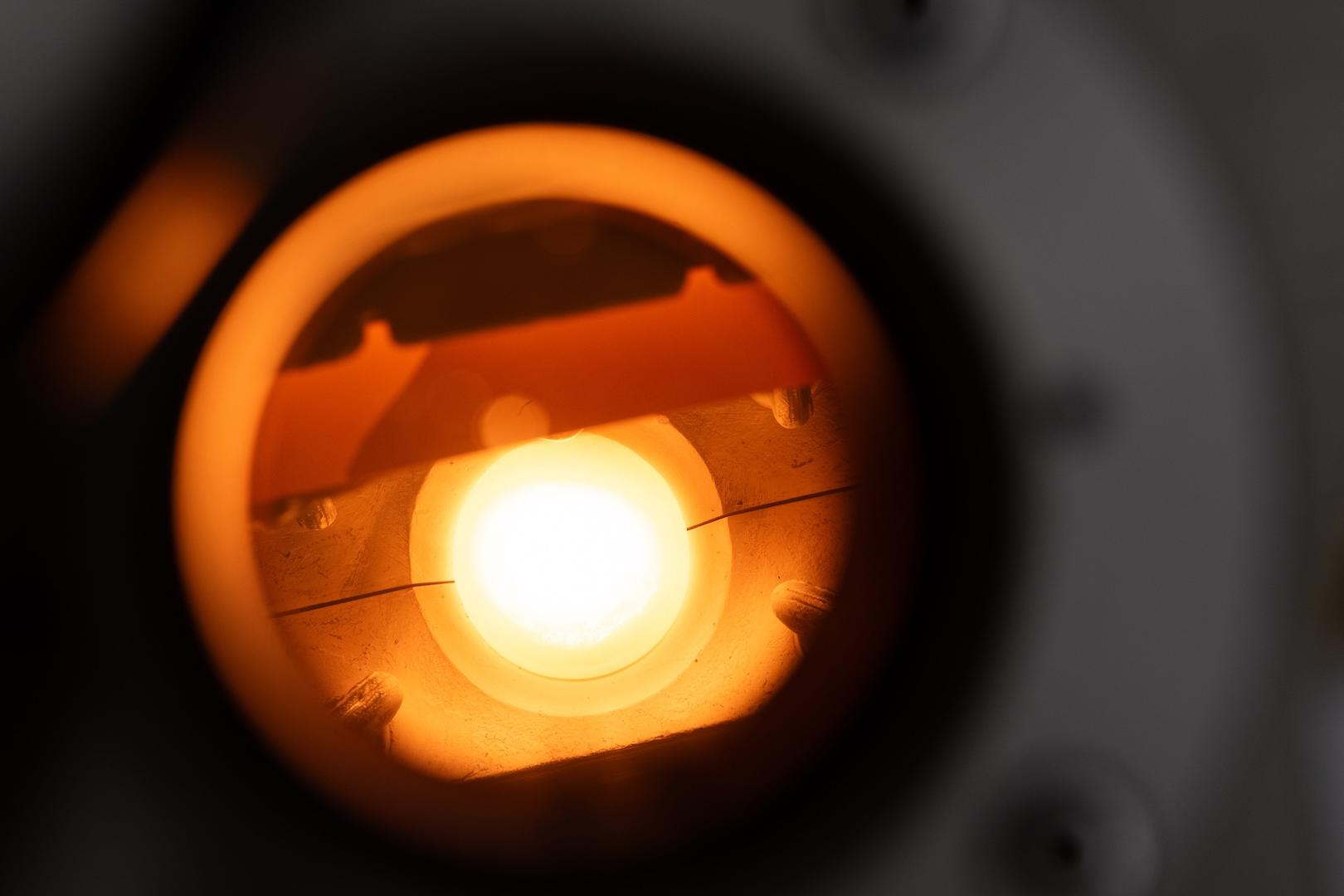 Close-up view of an illuminated optical component inside a scientific instrument, showcasing precision engineering by ZEISS.