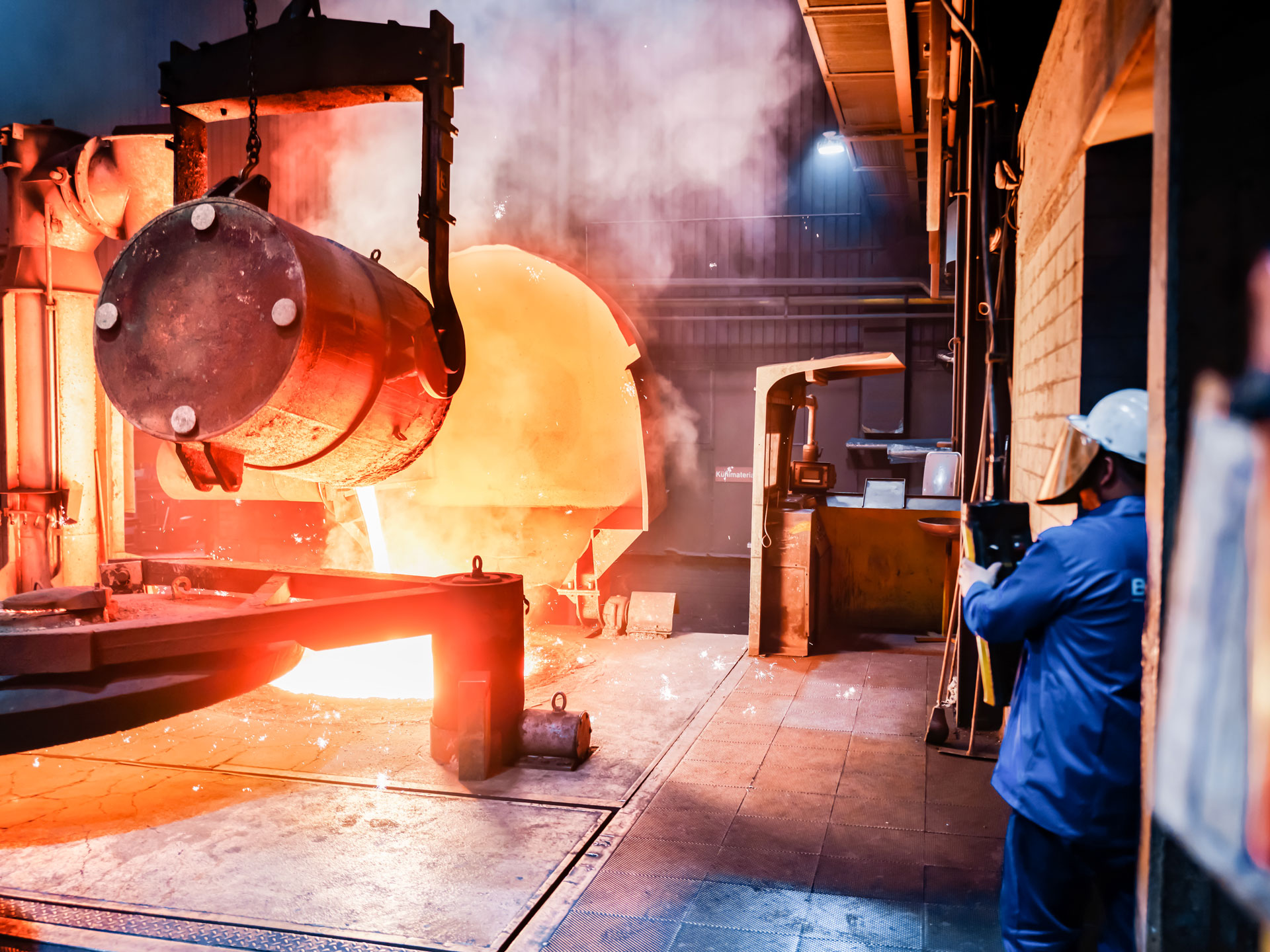 Industrial molten metal pouring process.