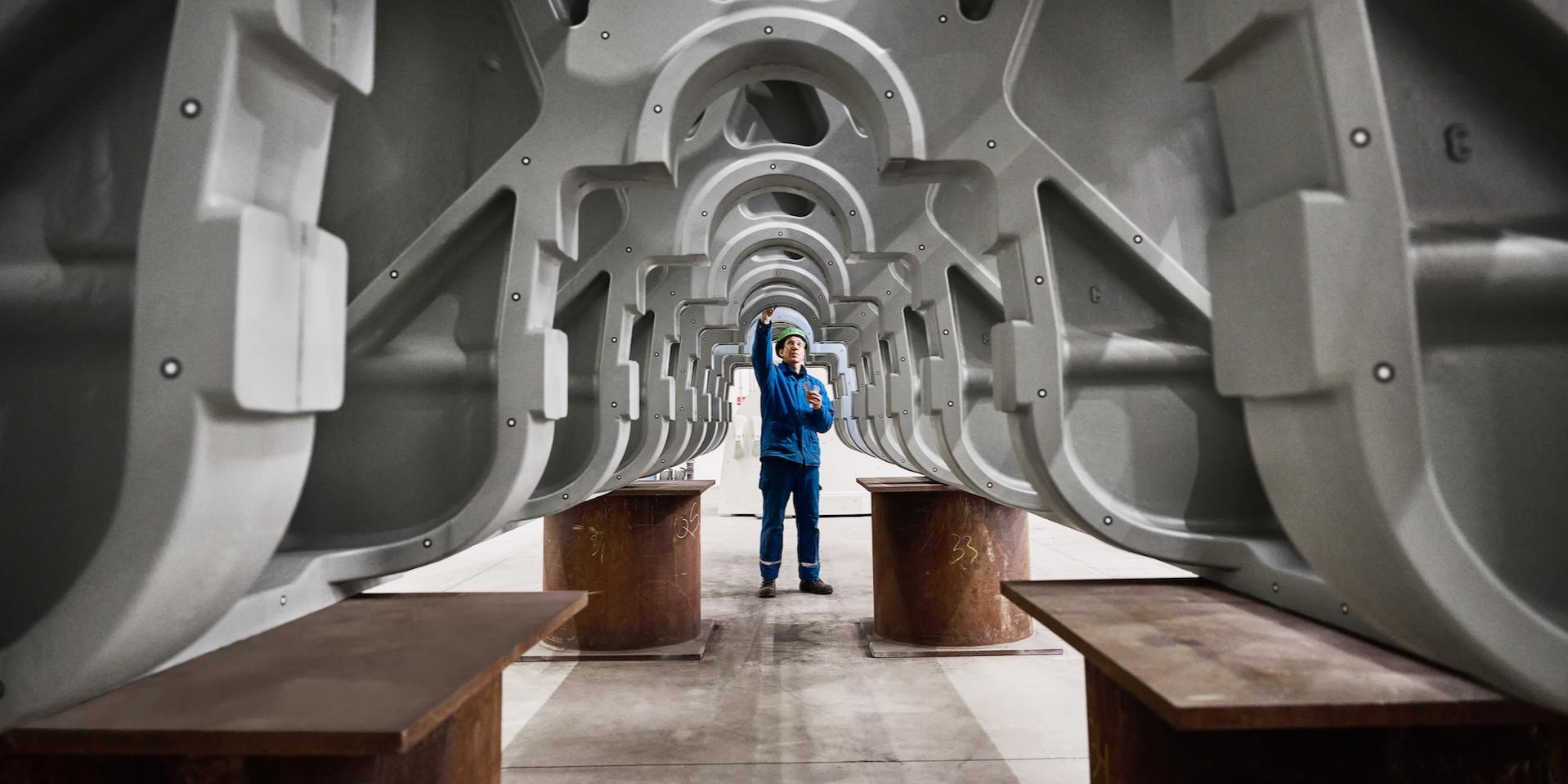 Engineer inspecting industrial metal framework.