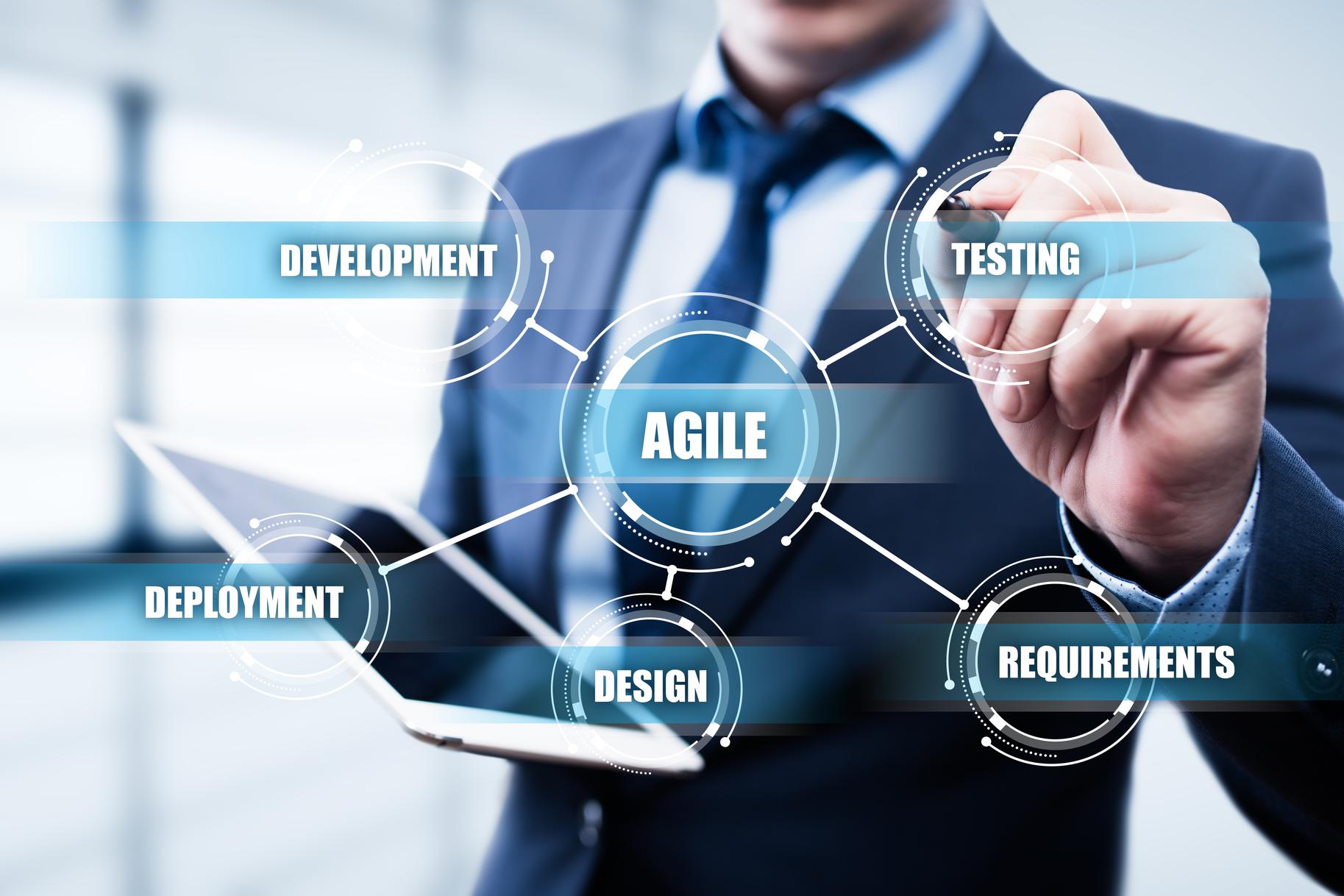 man in suit points at virtual diagram of agile development process