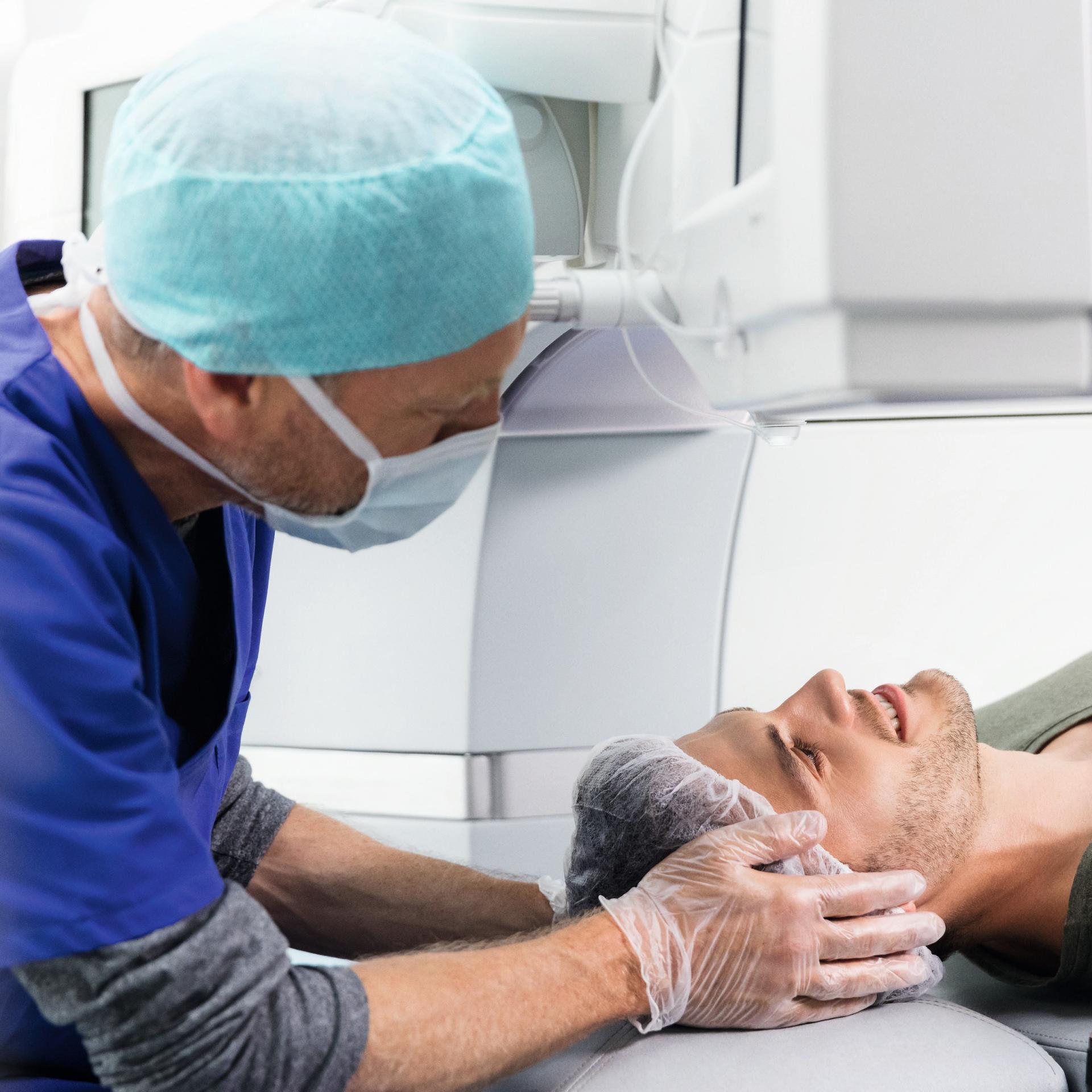 A medical professional prepares a patient for an eye procedure using advanced ZEISS diagnostic equipment.