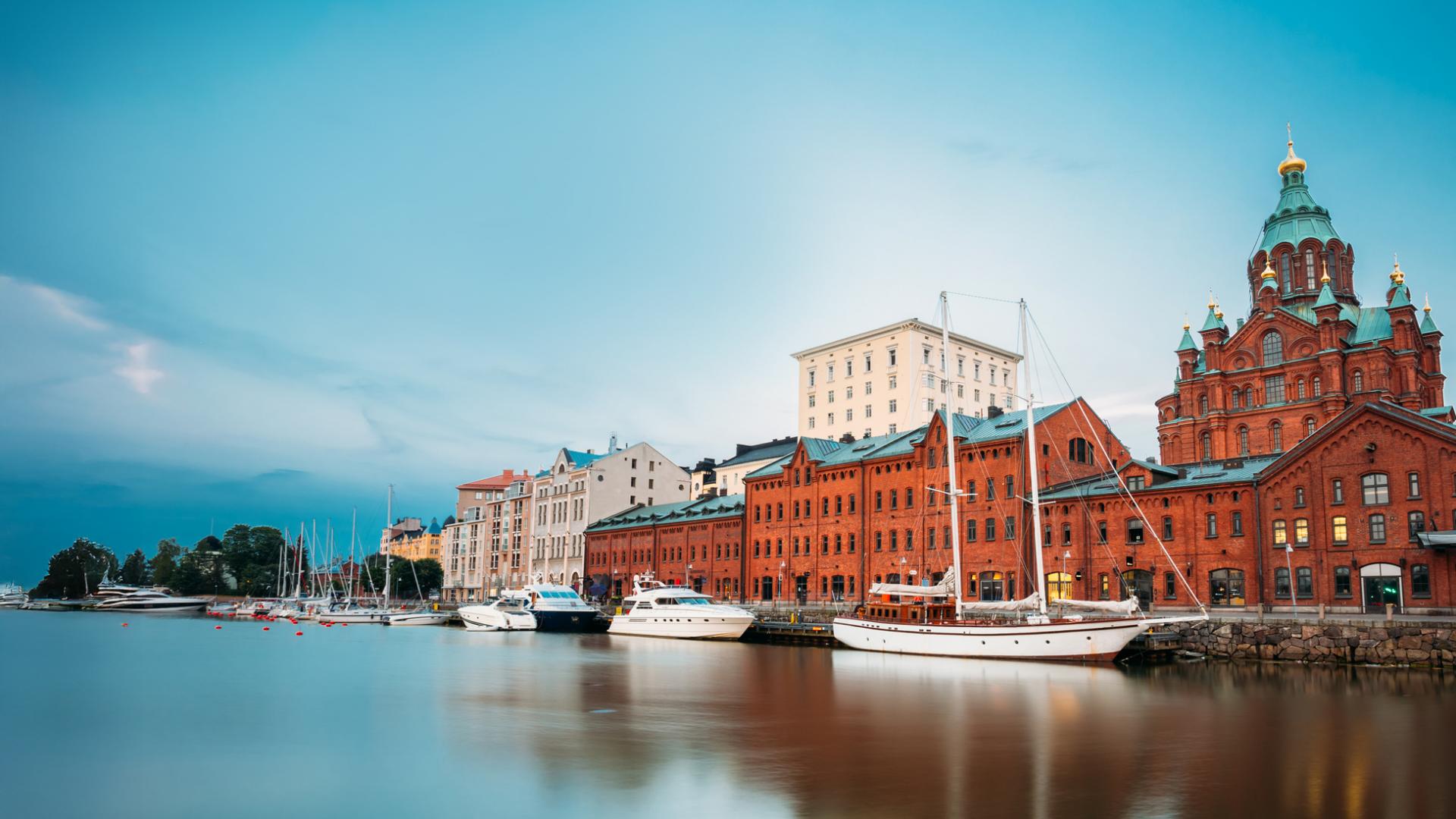 Colorful historic buildings line the waterfront of Copenhagen’s Nyhavn district, with sailboats docked along the calm canal under a vibrant sky, captured in high clarity to showcase ZEISS imaging quality.