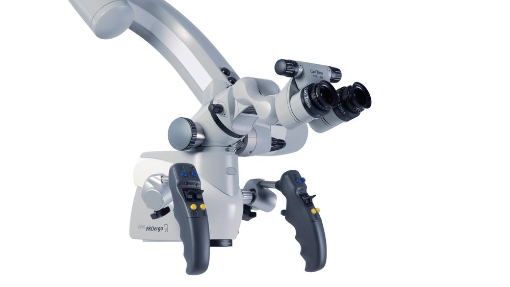 High-precision ZEISS surgical microscope featuring ergonomic dual handles, adjustable optics, and integrated lighting system.