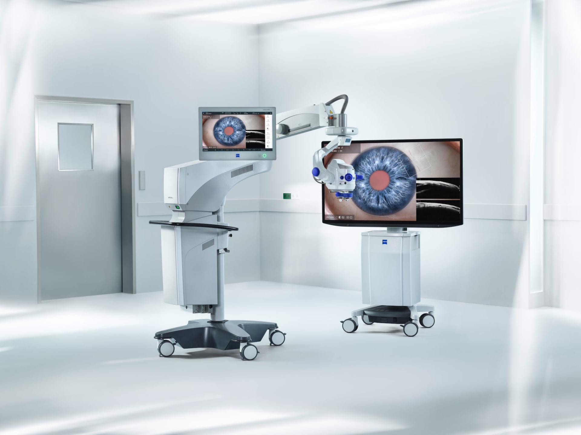 Medical imaging equipment with monitors displaying a detailed image of an eye, set up in a clean, modern clinical environment.