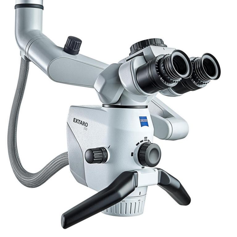 Close-up view of a ZEISS EXTARO 300 surgical microscope featuring dual eyepieces, control knobs, and articulated arms.