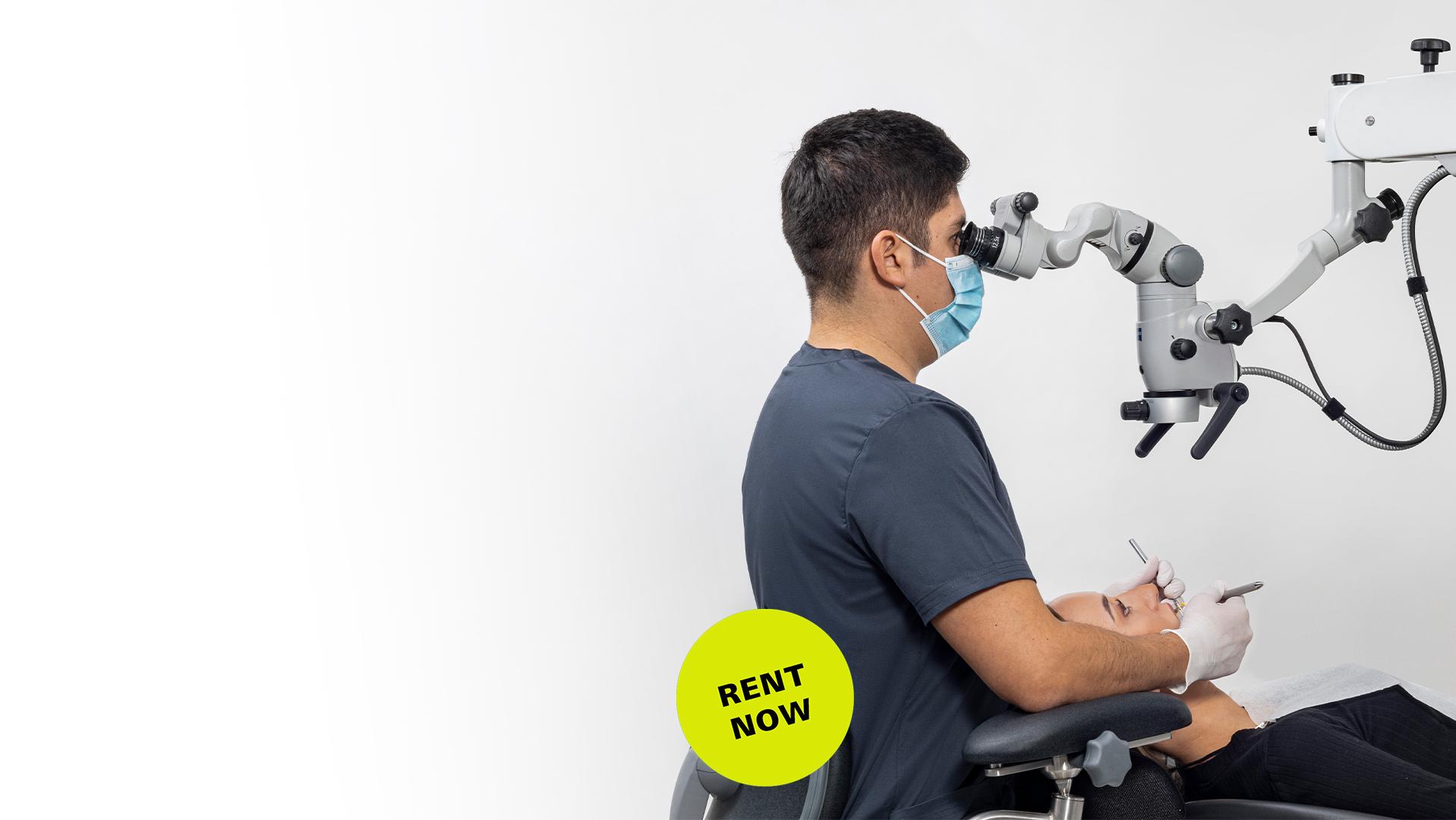 A medical professional uses a ZEISS surgical microscope while performing a procedure, with a "RENT NOW" label displayed in the foreground.