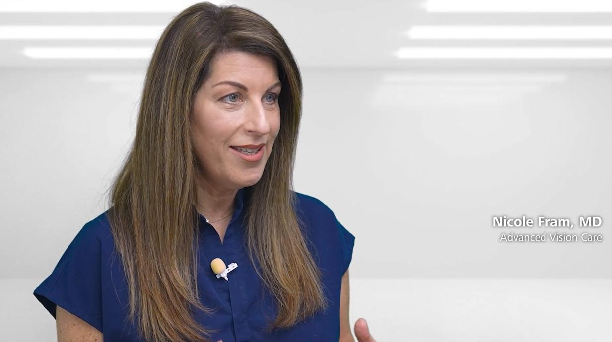 A woman in a blue blouse speaks in a well-lit studio setting with the text "Nicole Fram, MD – Advanced Vision Care" displayed beside her.