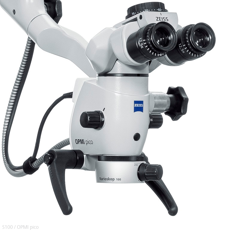 Close-up view of a ZEISS OPMI pico surgical microscope with dual eyepieces, adjustment knobs, and mounted on an articulated arm.