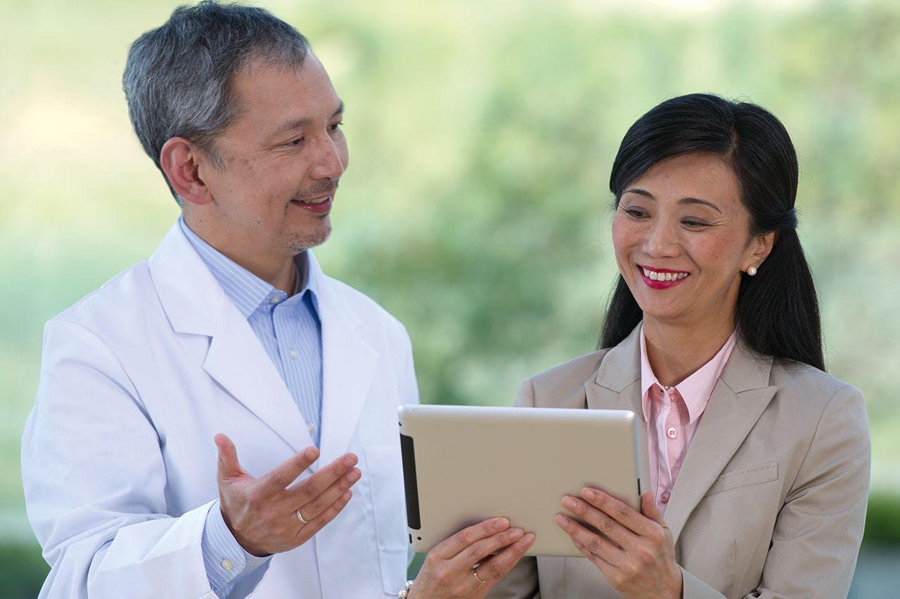 Doctor explaining different types of intraocular lenses (IOLs).