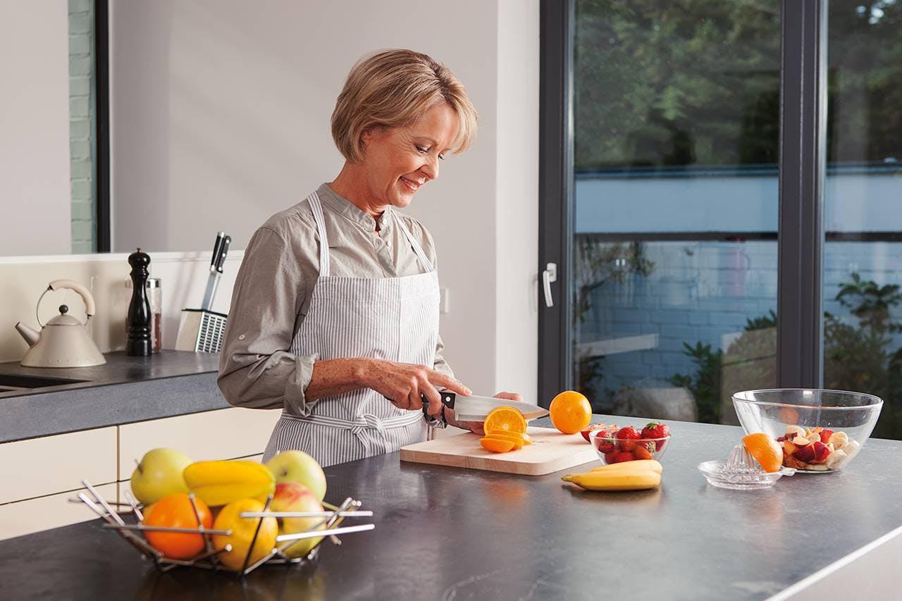 As a preventive measure of cataracts, a woman is preparing healthy food.