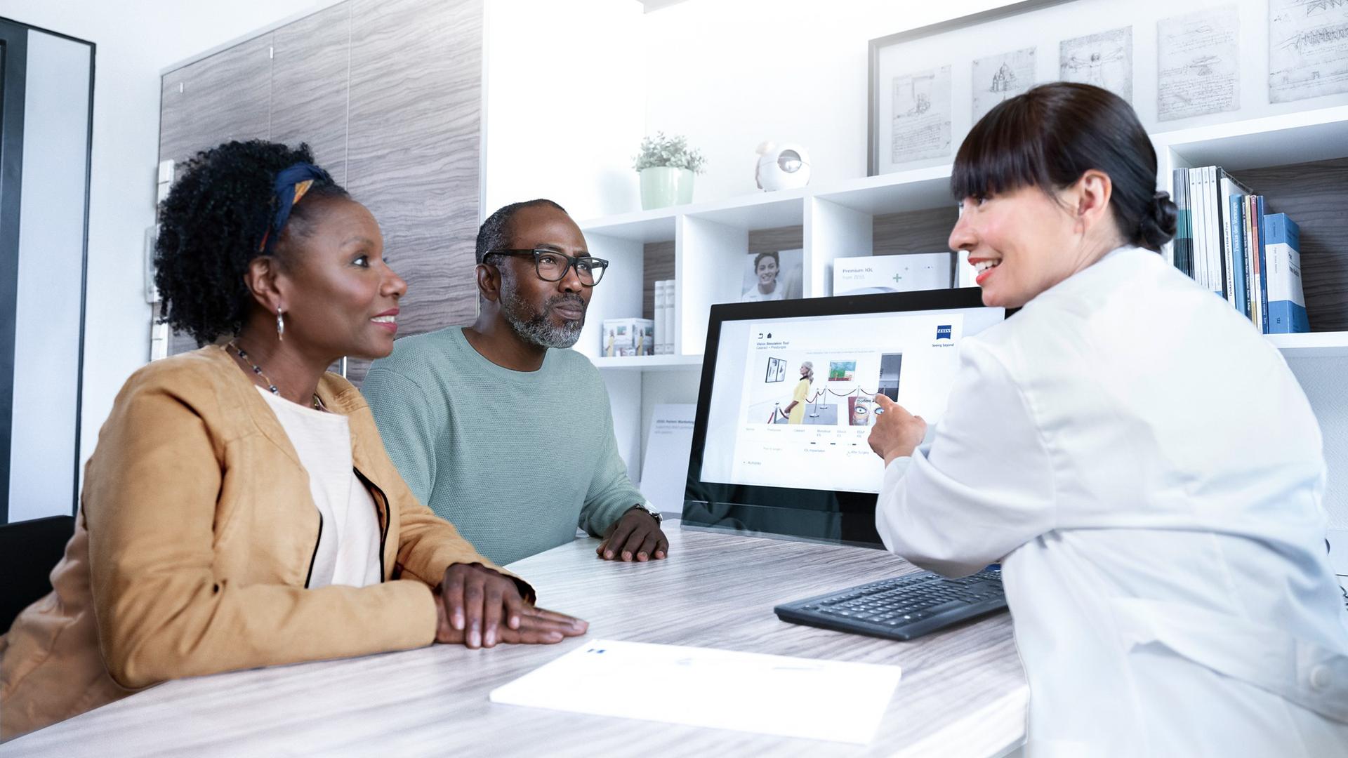 Doctor explaining a cataract lens to a patient.