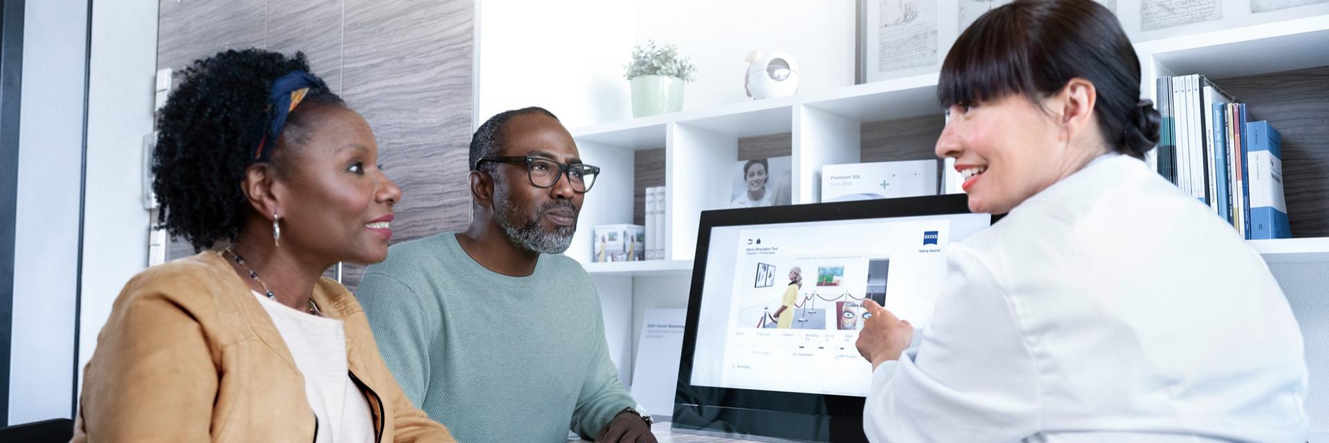 Doctor explaining a cataract lens to a patient.