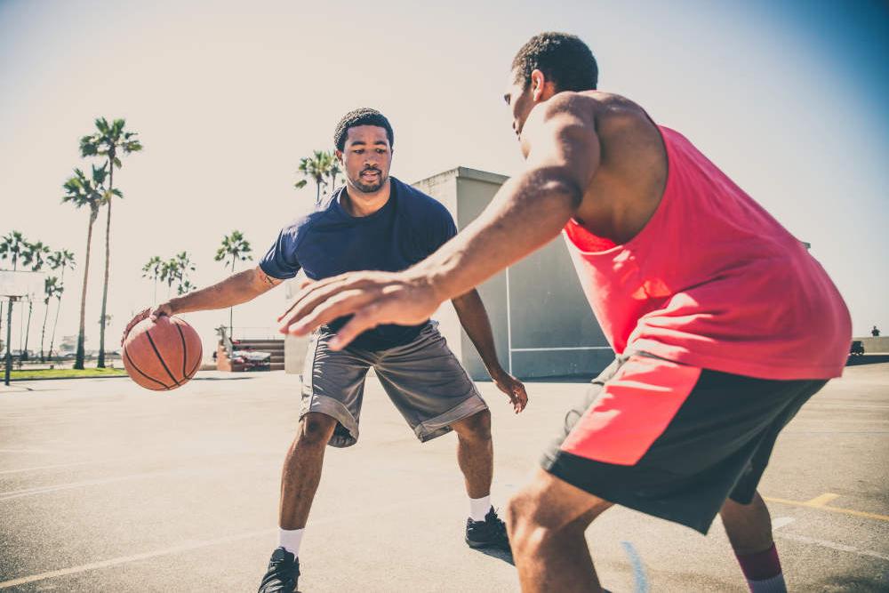 Two friends playing basketball.