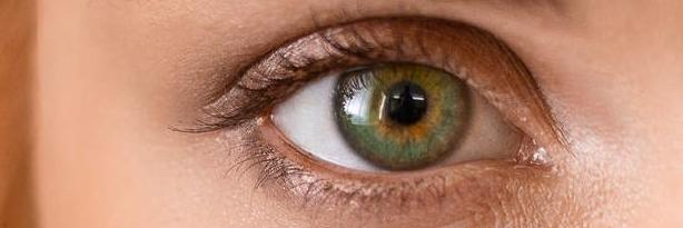 Green eyes of young redhead woman.