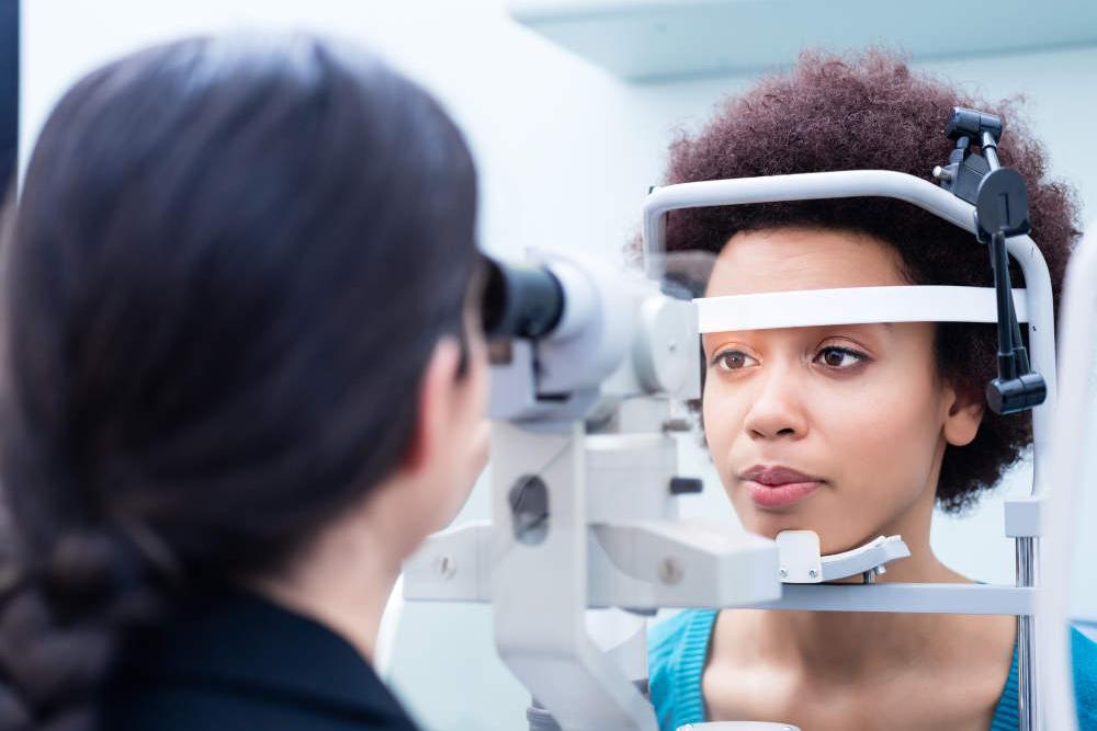 A woman’s eyes are measured by a doctor. 