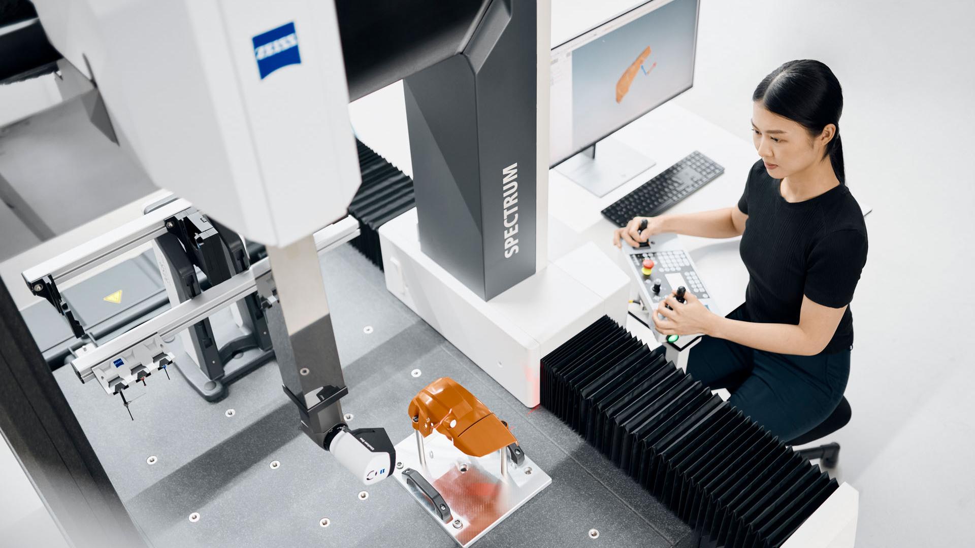Woman working on a component with the ZEISS SPECTRUM Scanning System