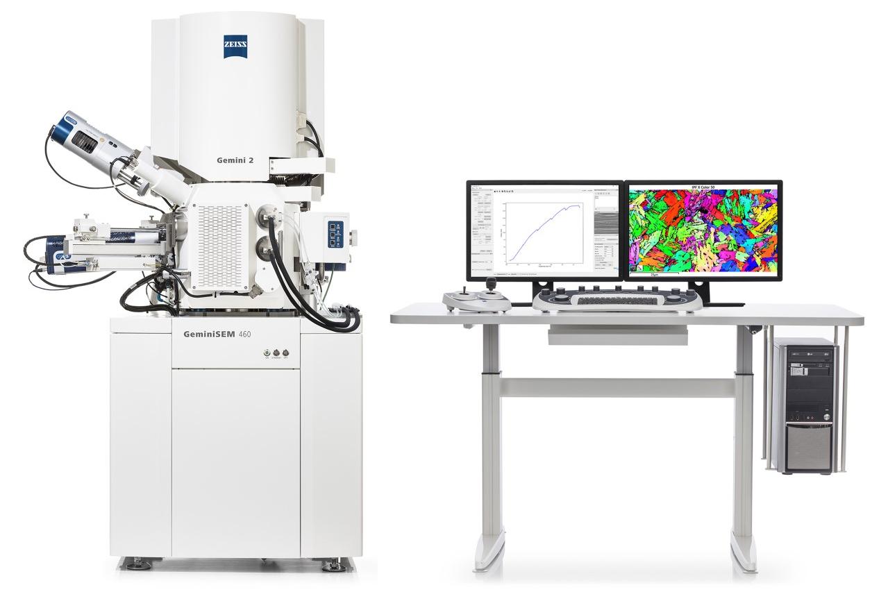 The in situ lab integrated into the SEM chamber and table with PC, monitors for SEM GUI and analytical software (e.g. EBSD), keyboard and joystick.