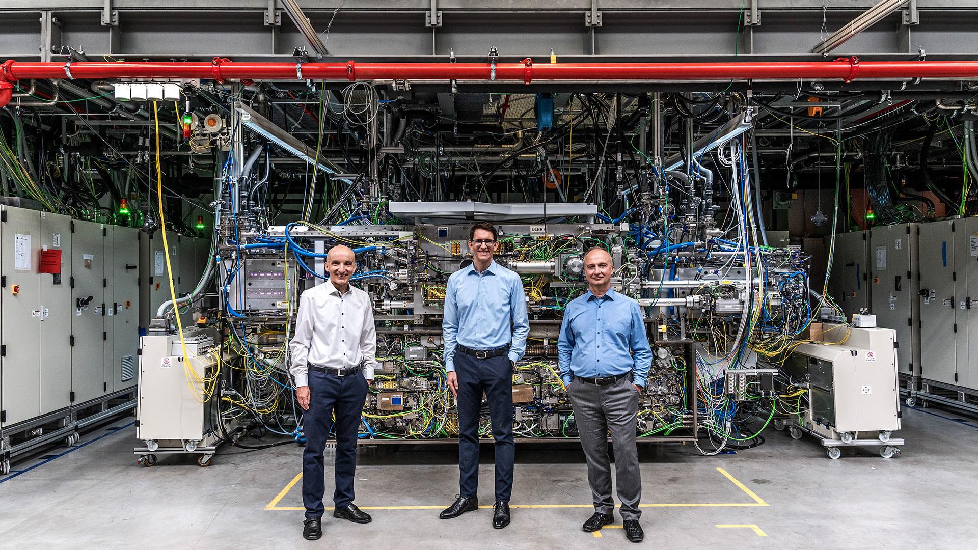 The team of experts standing in front of the world's strongest pulsed industrial laser