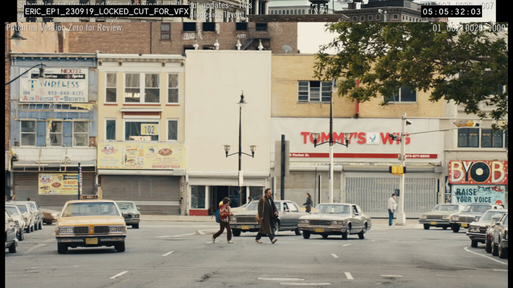 A group of people stands outdoors while a teenage boy reads from a paper as reporters hold microphones toward him.