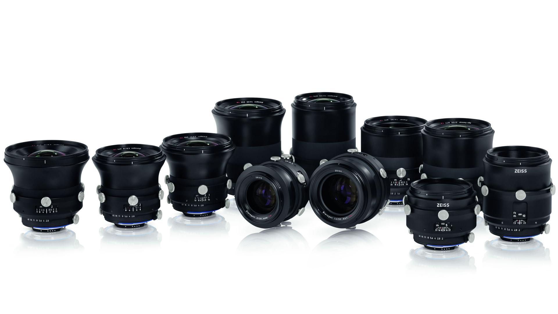 A collection of eleven professional ZEISS camera lenses arranged in rows on a white background.