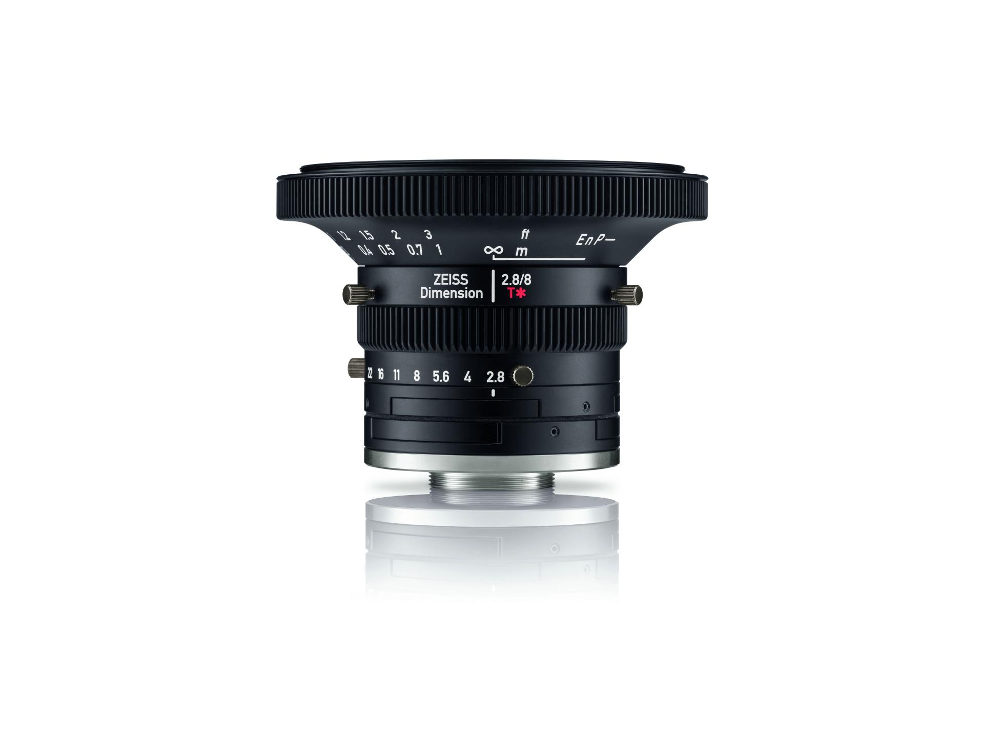 Professional cinema lens marked "ZEISS Dimension 2.8/8" with focus and aperture rings, displayed on a white reflective surface.