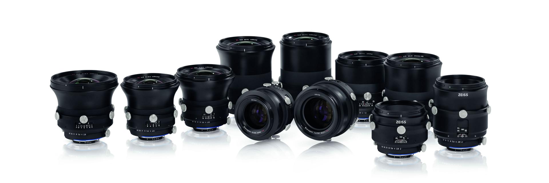 A collection of eleven professional ZEISS camera lenses arranged in rows on a white background.