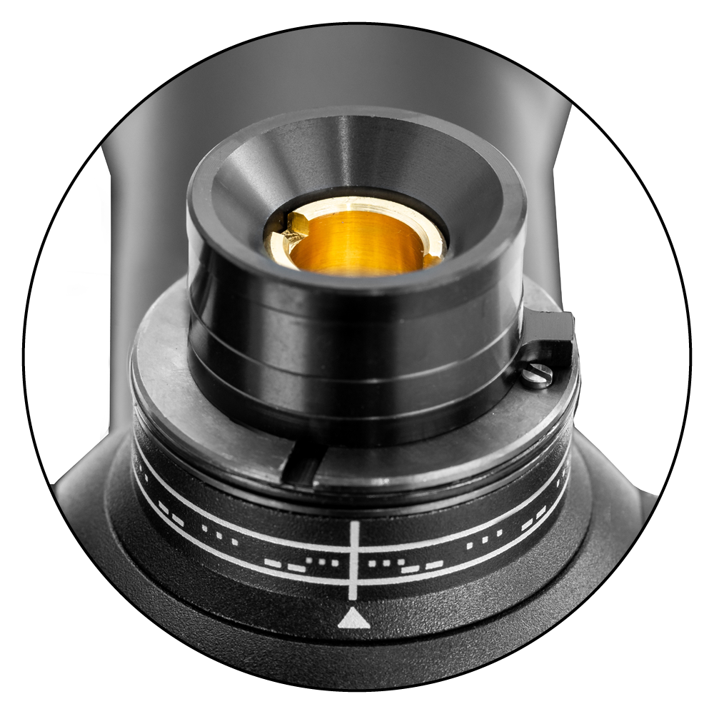 Close-up view of a ZEISS optical instrument featuring a precision adjustment dial with measurement markings and a gold-coated lens element.