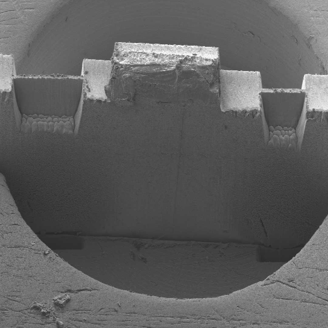 Laser preparation of two H-Bar lamellas in a 3 mm wide copper semicircular grid standing upright.