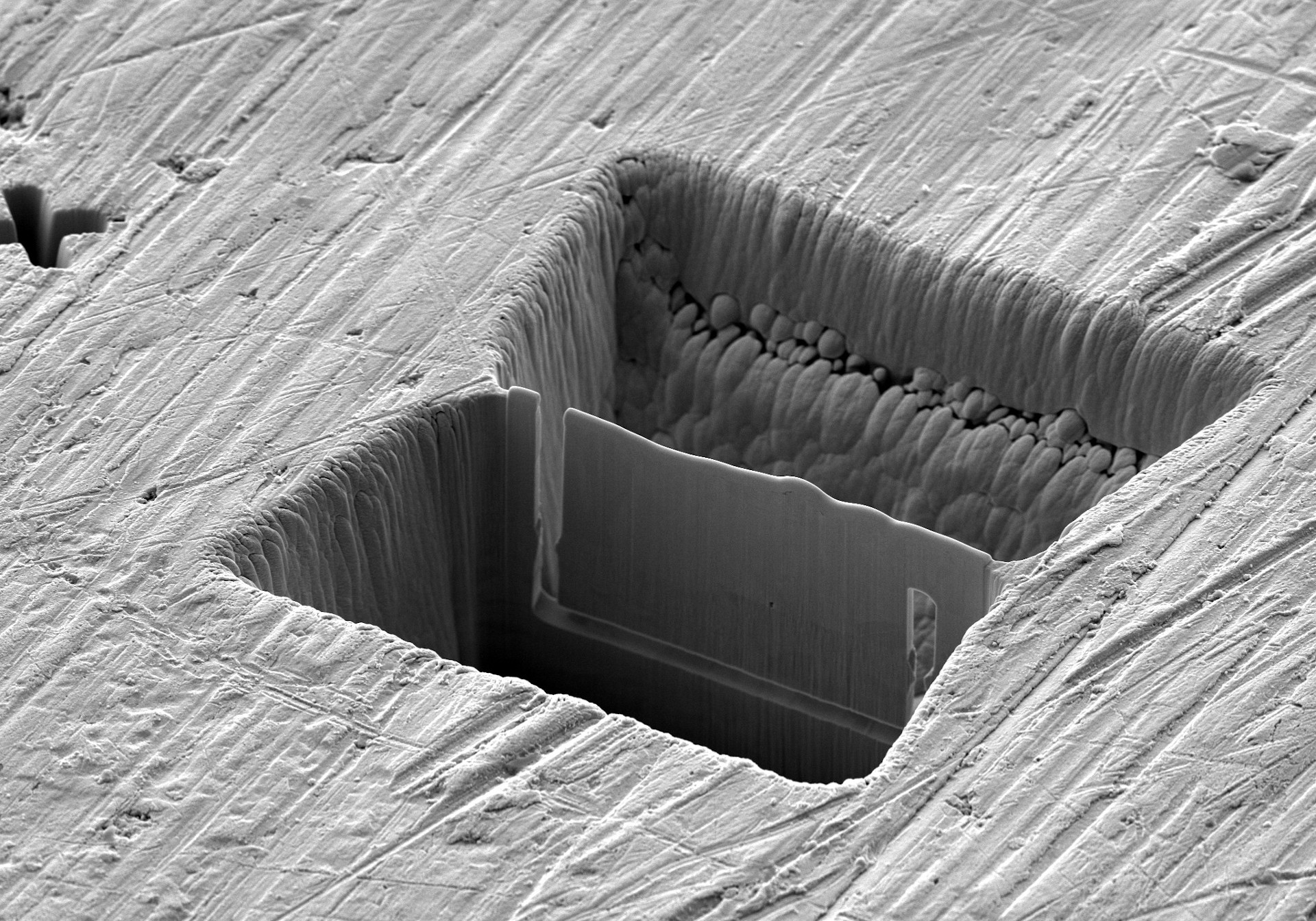 Multi-site lamella preparation of a 3 x 2 array of laser- machined chunks followed by FIB millingfor precise thinning to produce a < 2 µm TEM lamella.