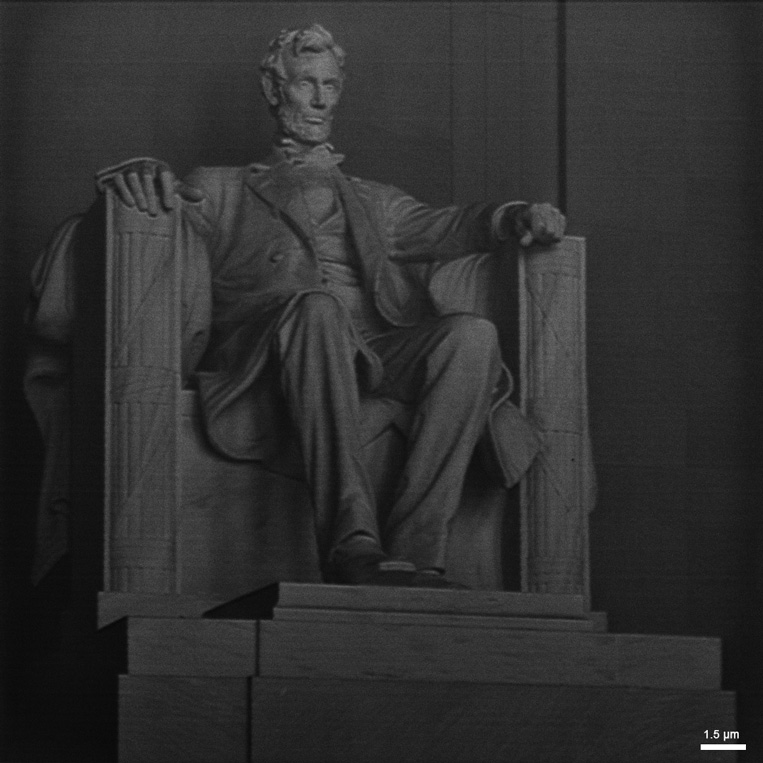 A FIB grayscale rendering of the Lincoln Memorial is patterned into silicon with the FIB beam.